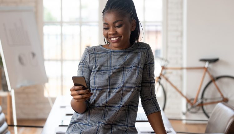 A businesswoman using social media on a mobile phone