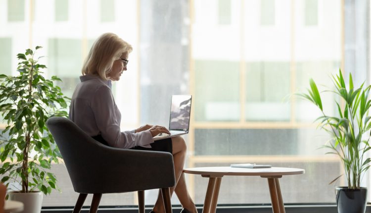 Businesswoman using a laptop in a neat office