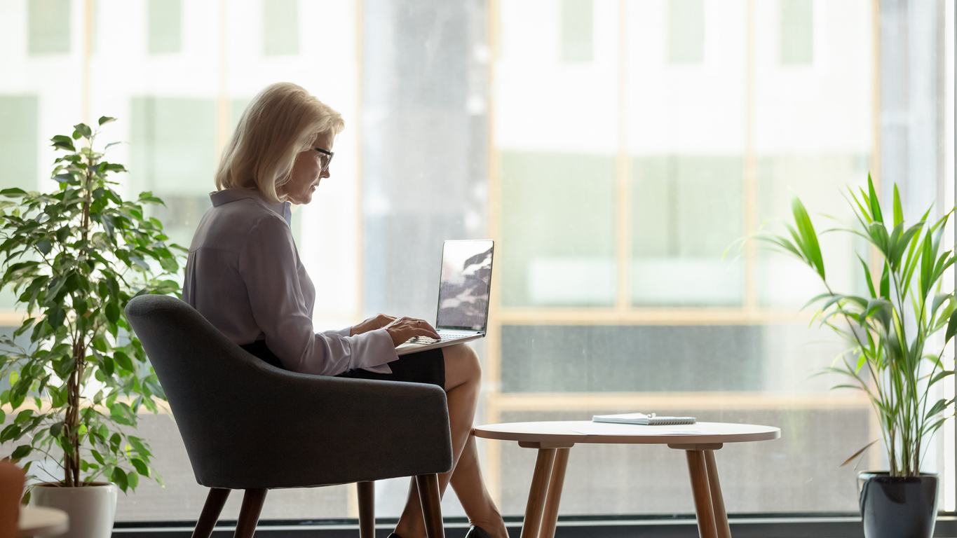 Businesswoman using a laptop in a neat office