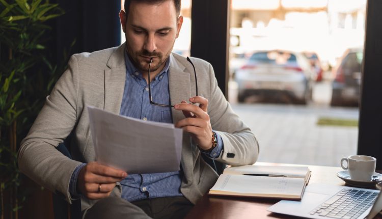 Businessman reading report in office