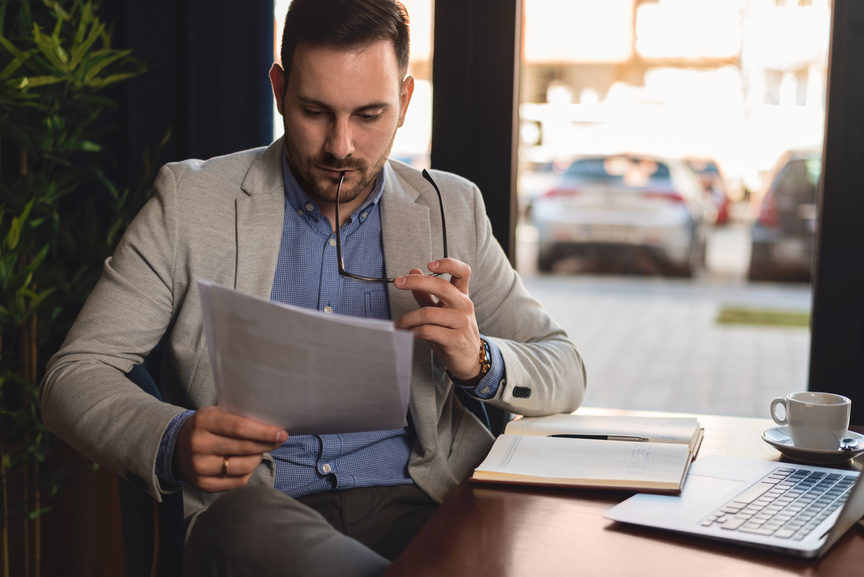 Businessman reading report in office