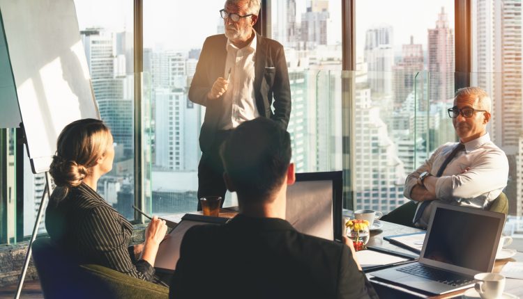 Executive team meeting in skyscraper office