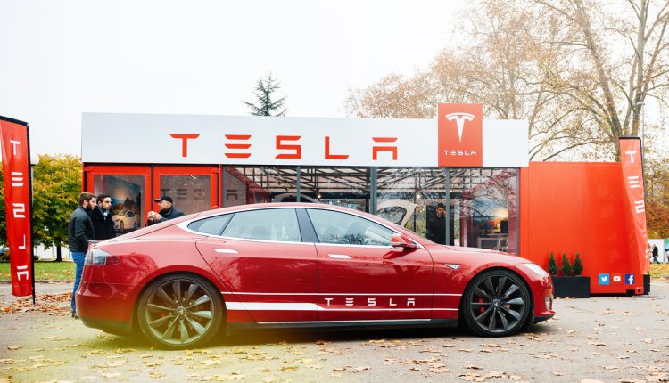 Tesla Model S parked in front of showroom