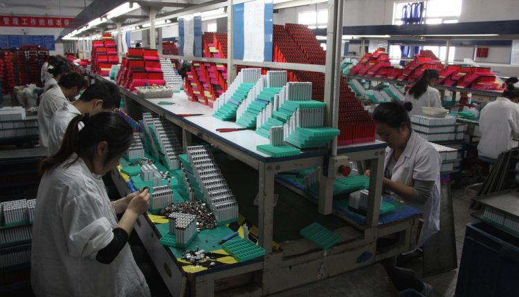 Chinese factory workers assembling lighters