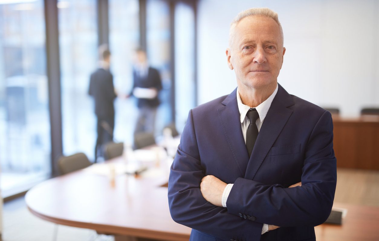 Senior businessman in boardroom