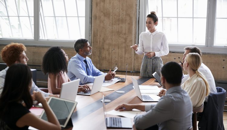 Female manager addressing team at a board meeting