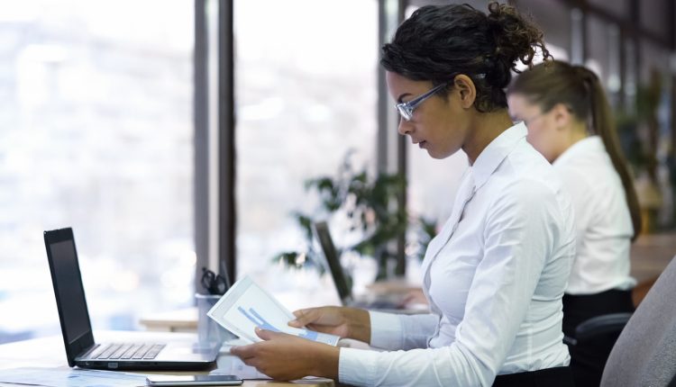 Female manager reading charts in modern office