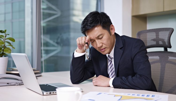 Stressed executive using a laptop