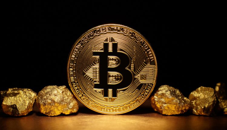 Bitcoin pictured between gold nuggets