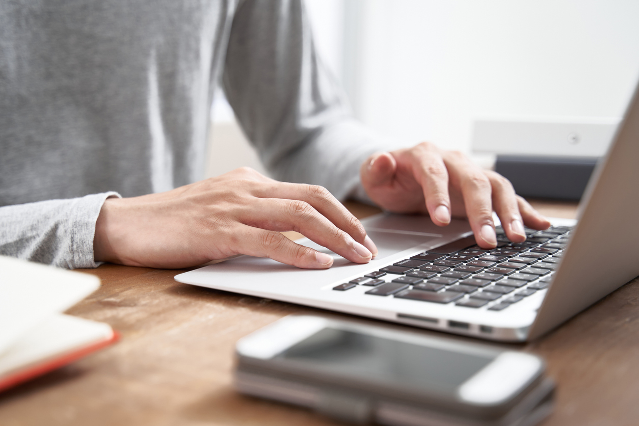 Businessman in plain clothes using a laptop