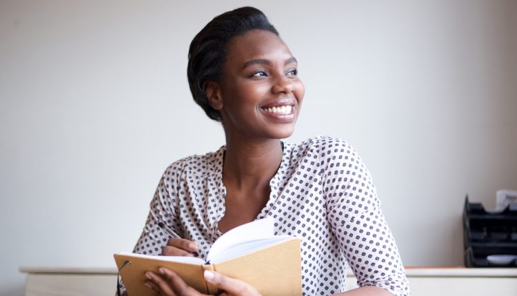 Young female business leader reading a book