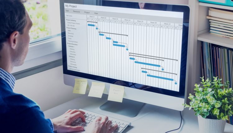 Project manager working on a Gnatt chart schedule