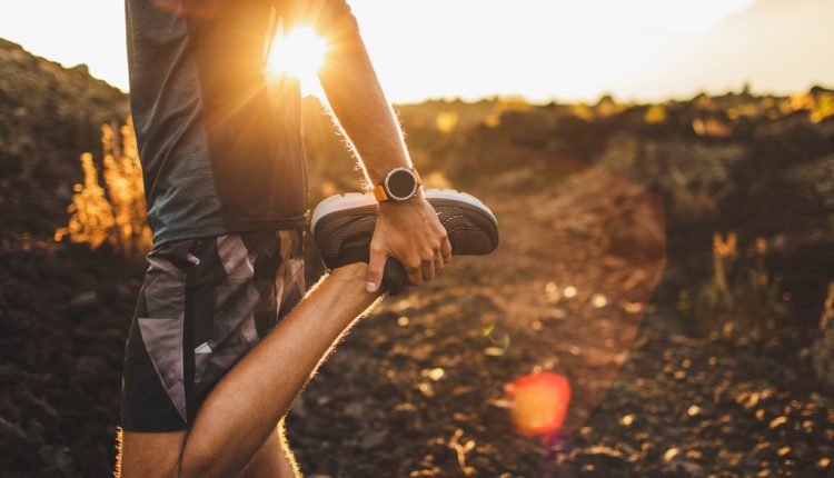 Male runner stretching outdoors