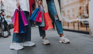 Gen Z women with colourful shopping bags