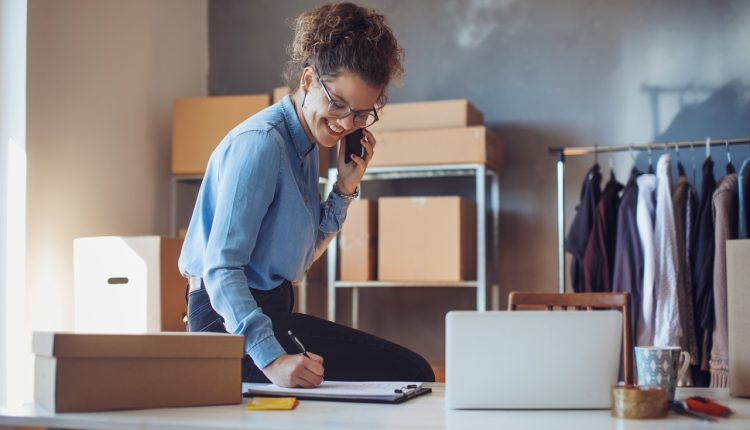 Young e-commerce business entrepreneur on phone