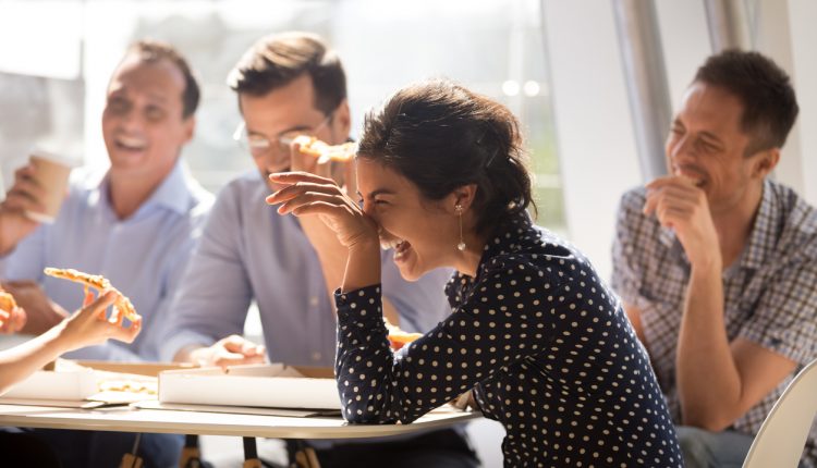 Coworkers laughing at group break