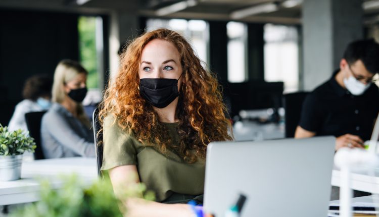 Young employee wearing face mask at work