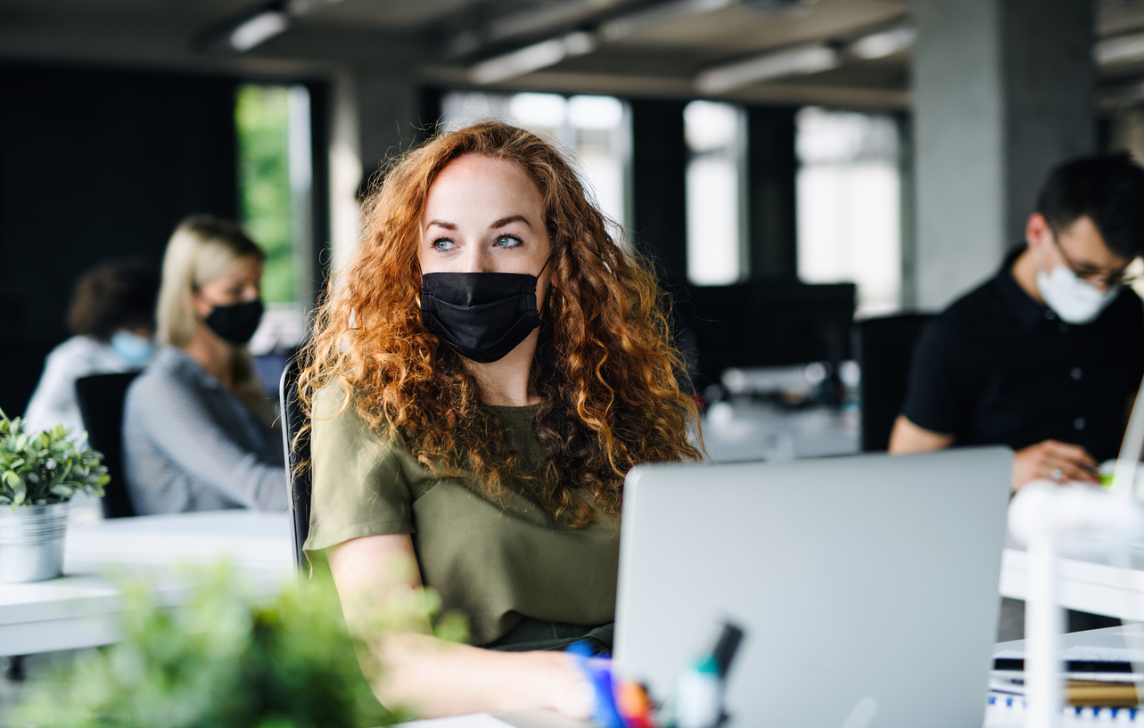 Young employee wearing face mask at work