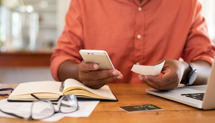 Man processing payment via smartphone