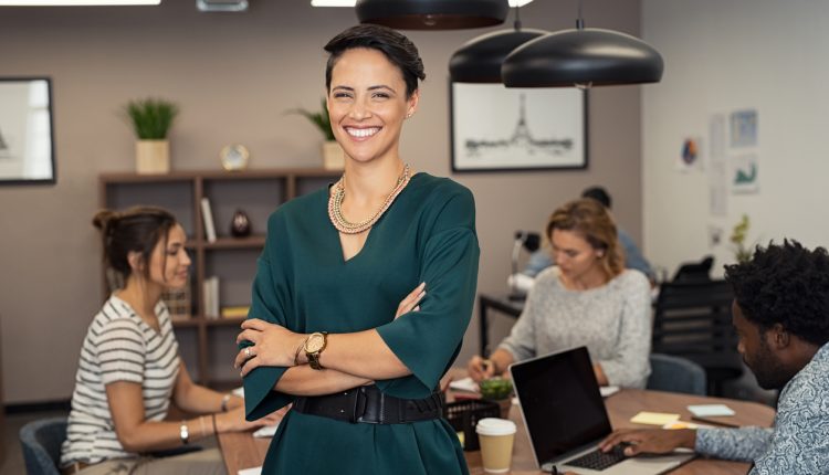 Successful business woman stood infront of team