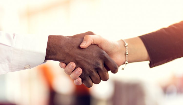 Two business professionals shaking hands