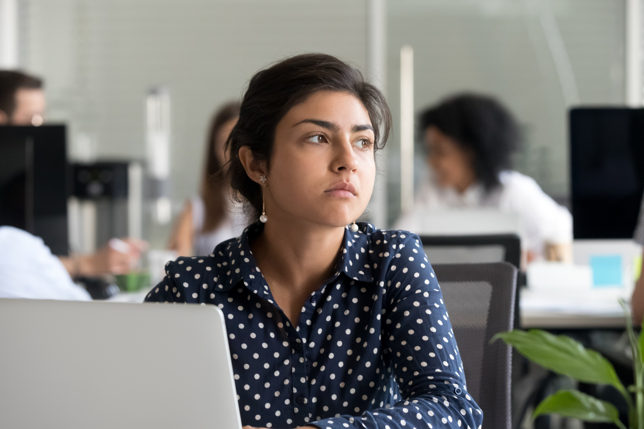 Dissatisfied employee sat at desk