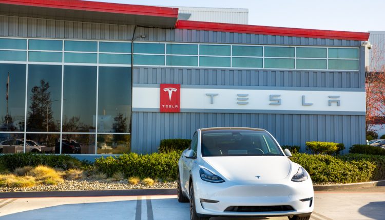 Tesla car parked outside Tesla factory plant