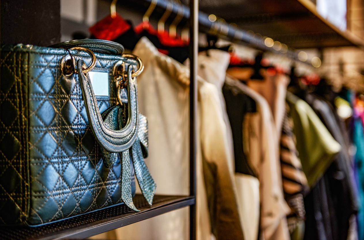 Handbags and clothes in a second-hand fashion store