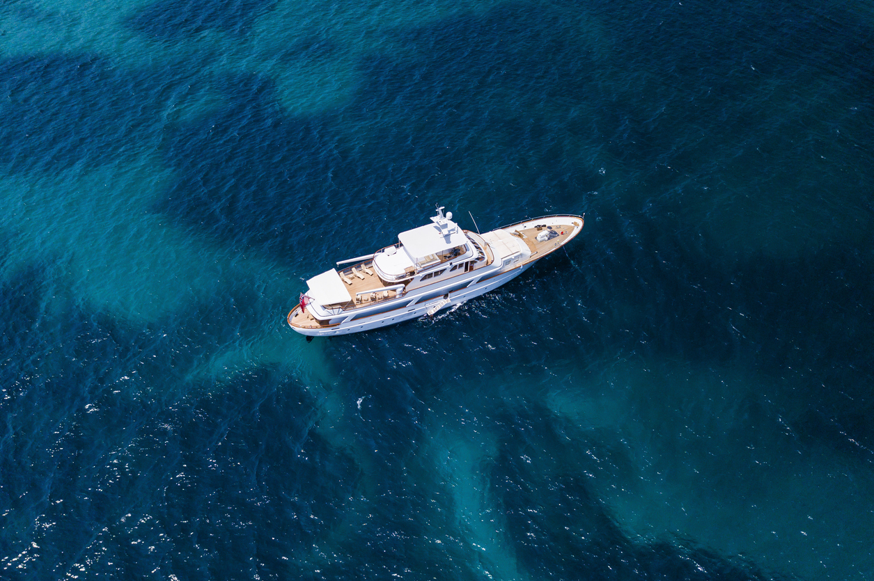 Aerial view of a luxury yacht on a turquoise and transparent sea