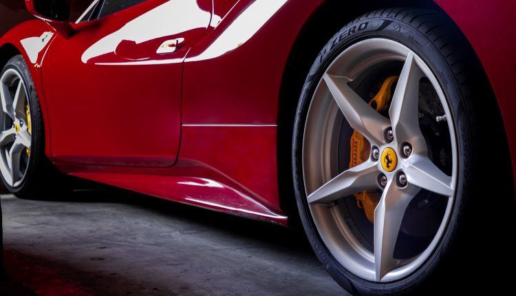 Close-up of Wheel of Red Ferrari Sports Car. Ferrari is Italian sports car