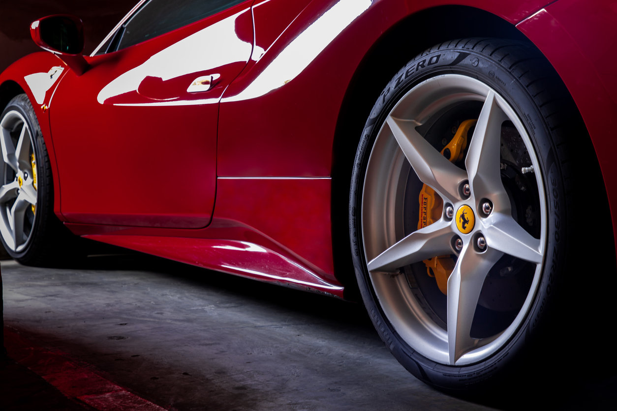 Close-up of Wheel of Red Ferrari Sports Car. Ferrari is Italian sports car