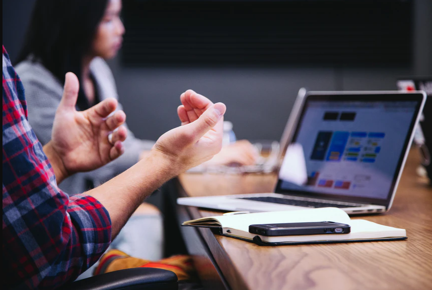 Business leader communicating with customer in meeting