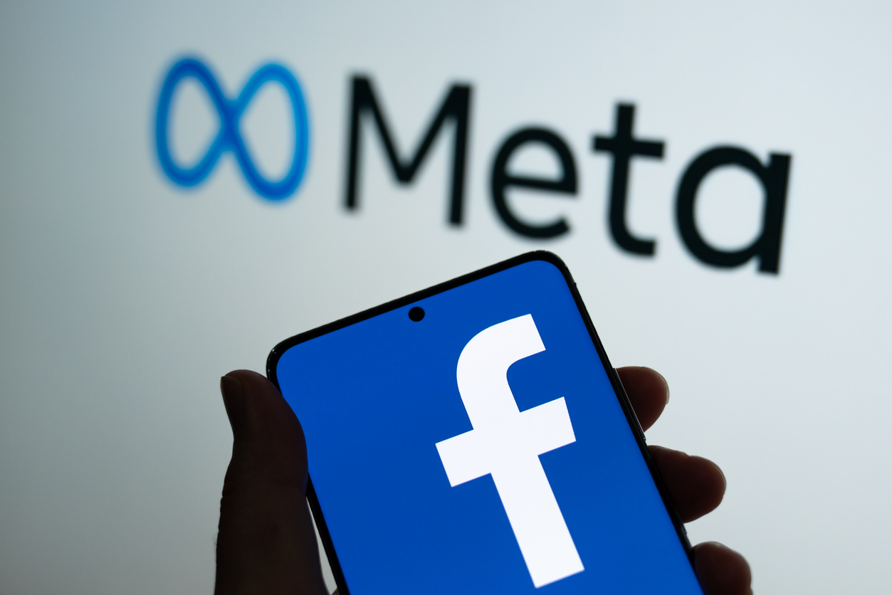 Meta logo with Facebook logo on phonescreen