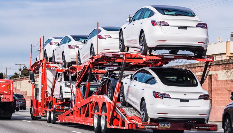 Car transporter carrying Tesla Model 3 vehicles