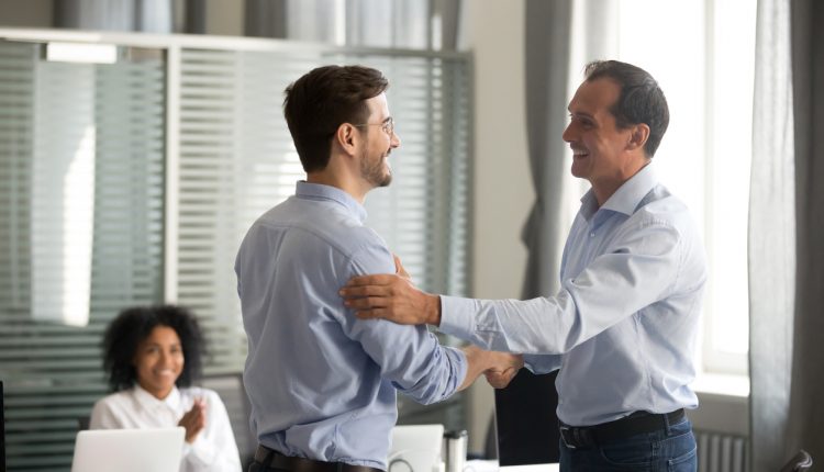 Business leader smiling with employee