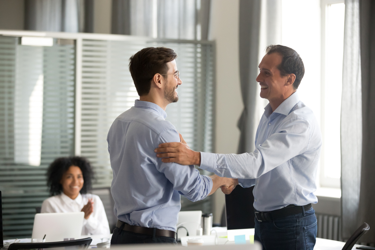 Business leader smiling with employee