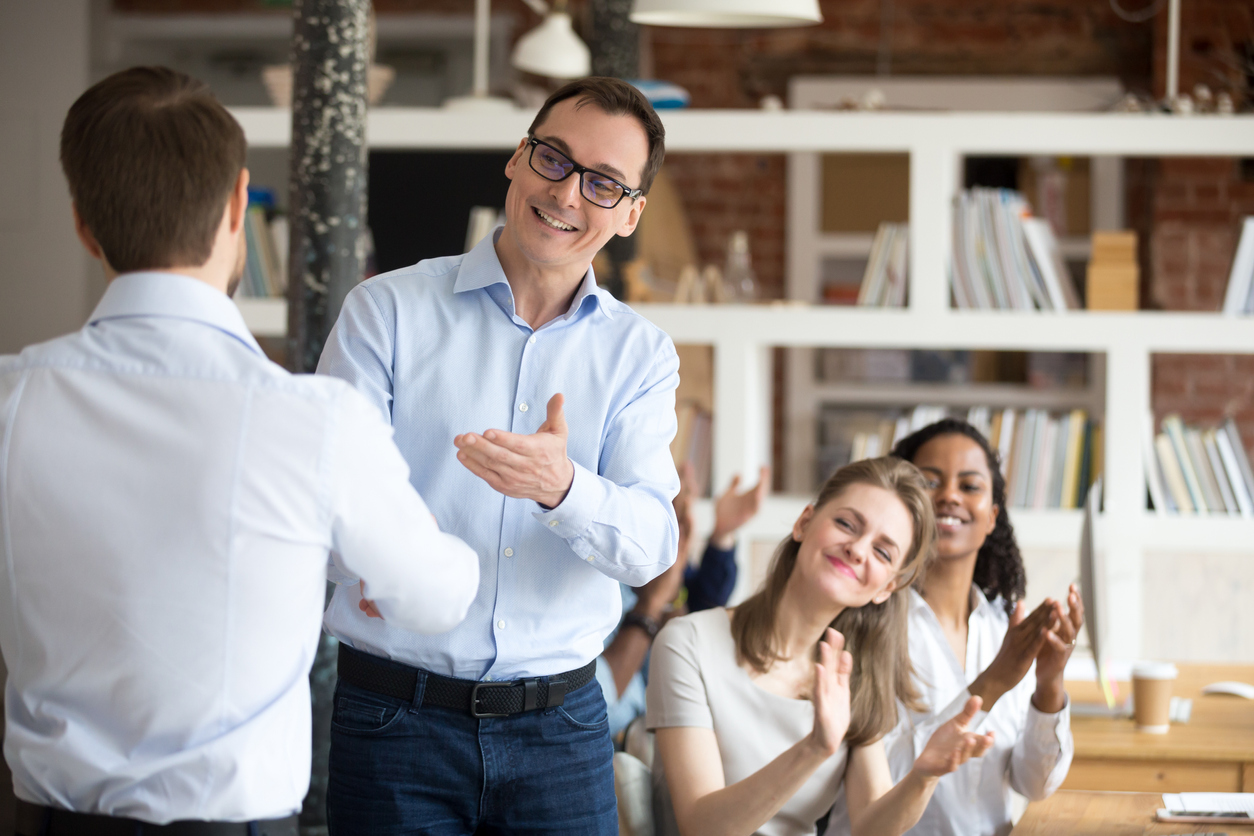 Happy employees in office meeting