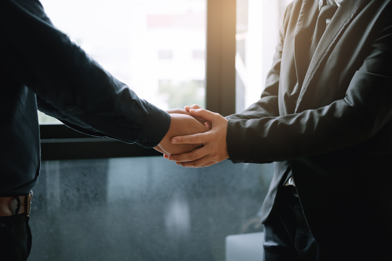 Business colleagues holding hands