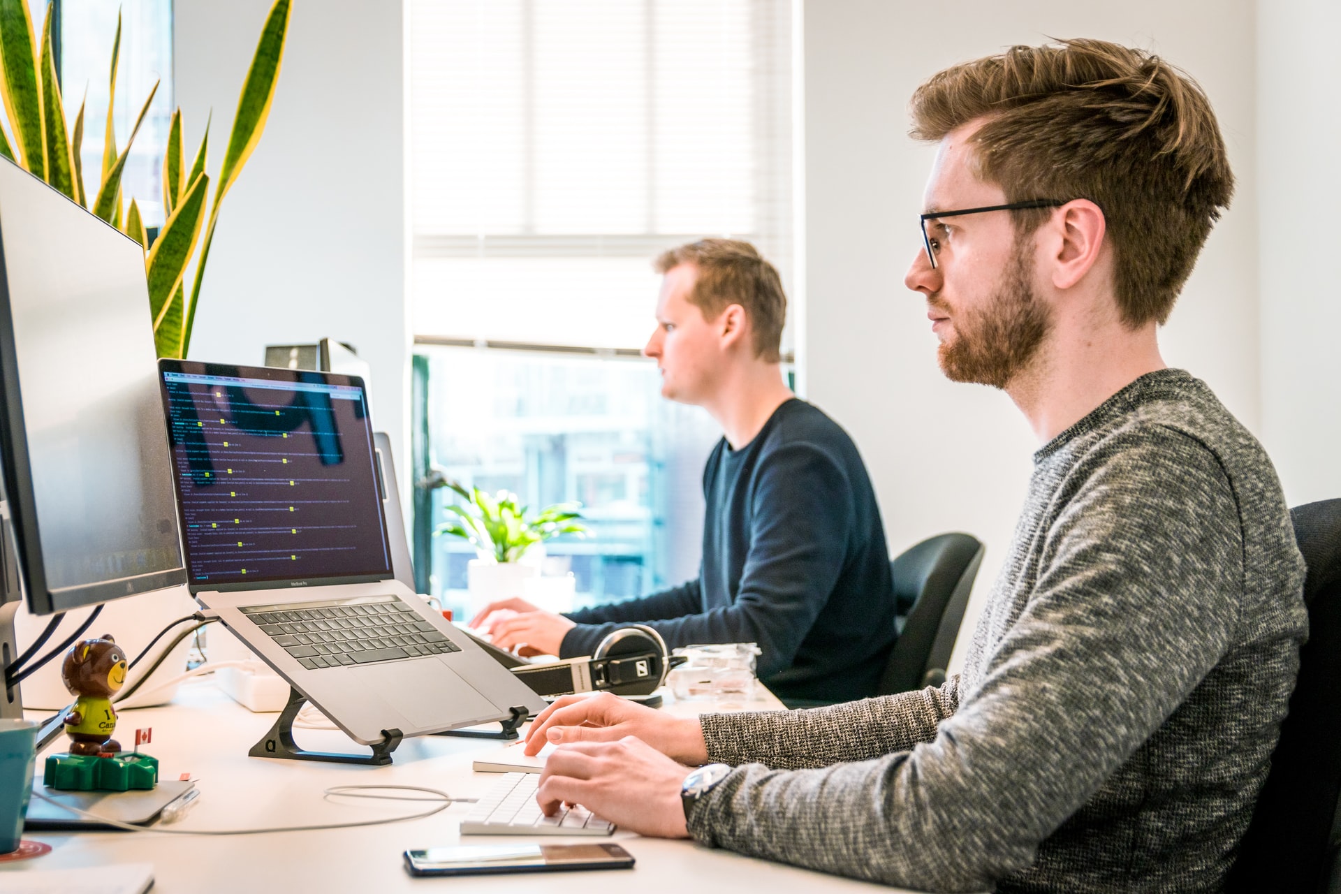 Employees working on customer services software at desktops