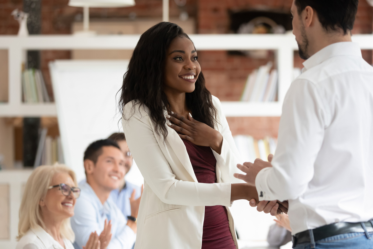 Appreciated employee shaking hands with boss