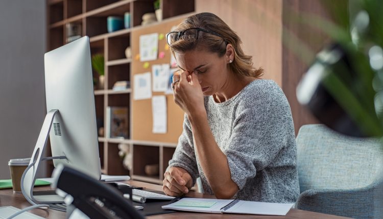 Employee suffering from stress in work office