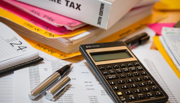 Income tax book by calculator and pens