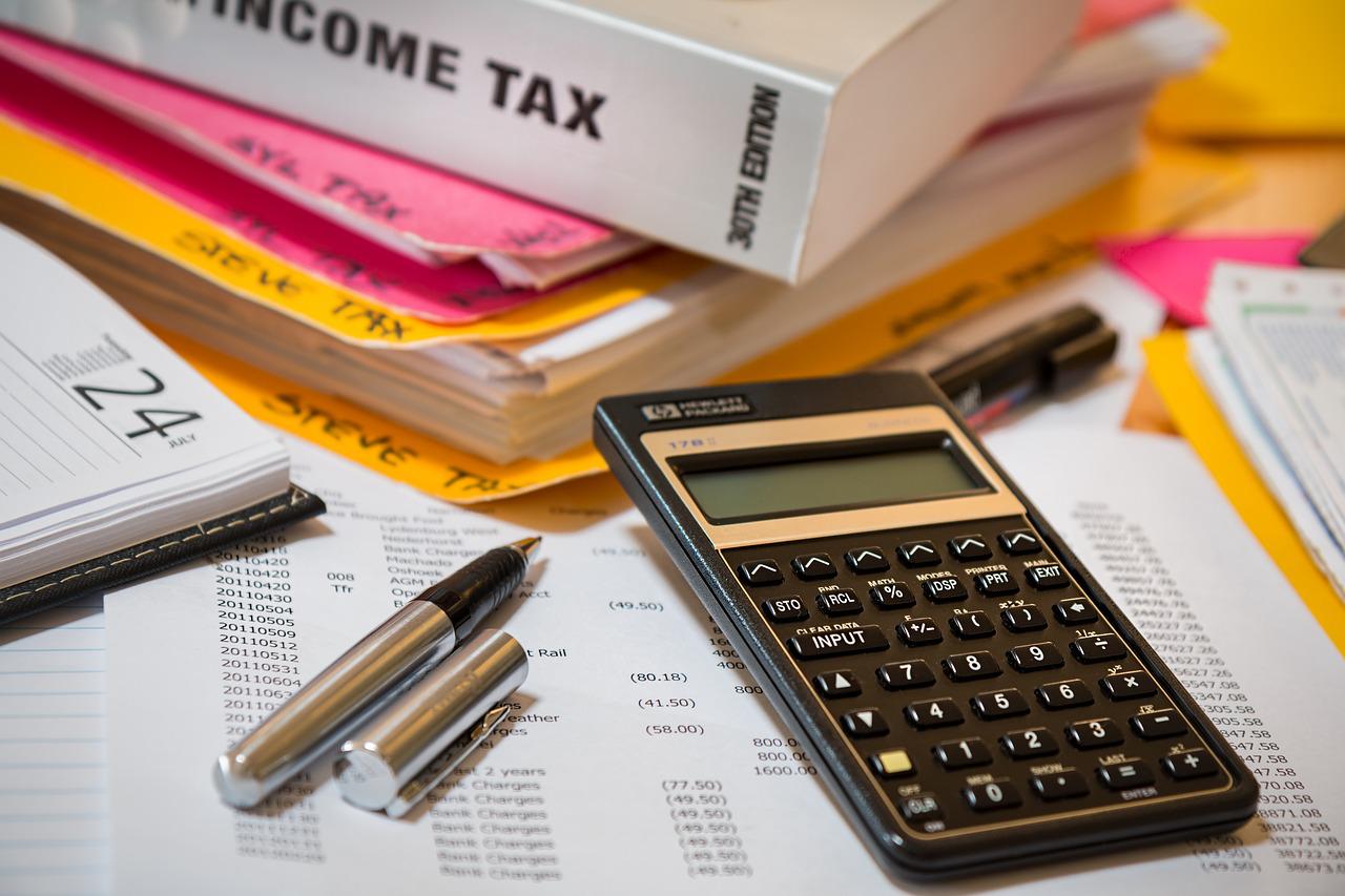 Income tax book by calculator and pens