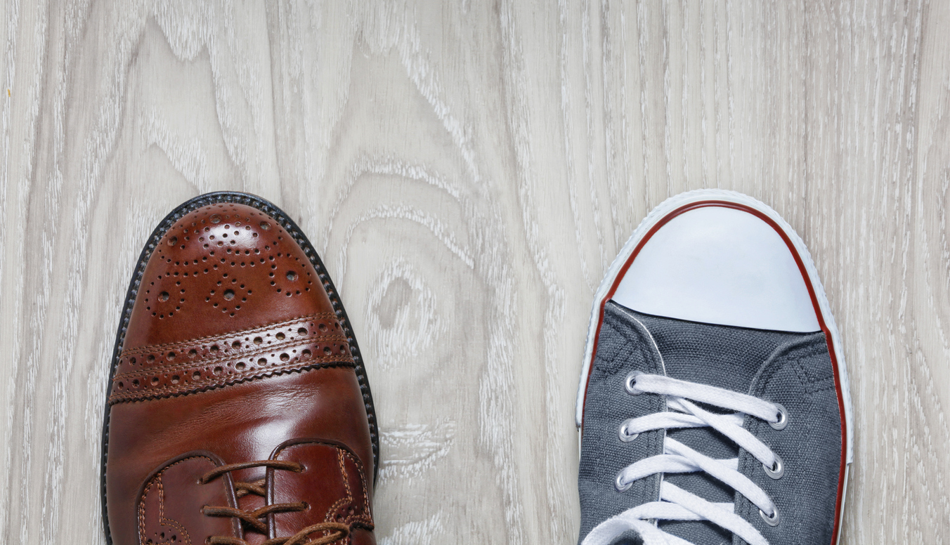 A leather shoe and a sports shoe symbolising work/life balance