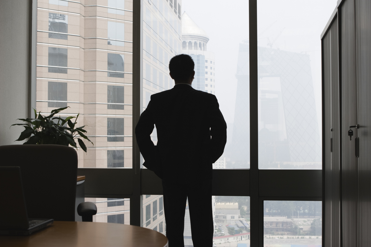 Aspiring CEO looking out of window