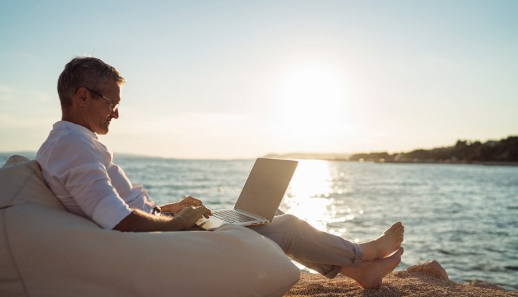 Corporate executive working on beach