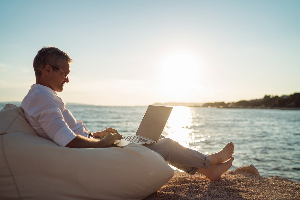 Corporate executive working on beach