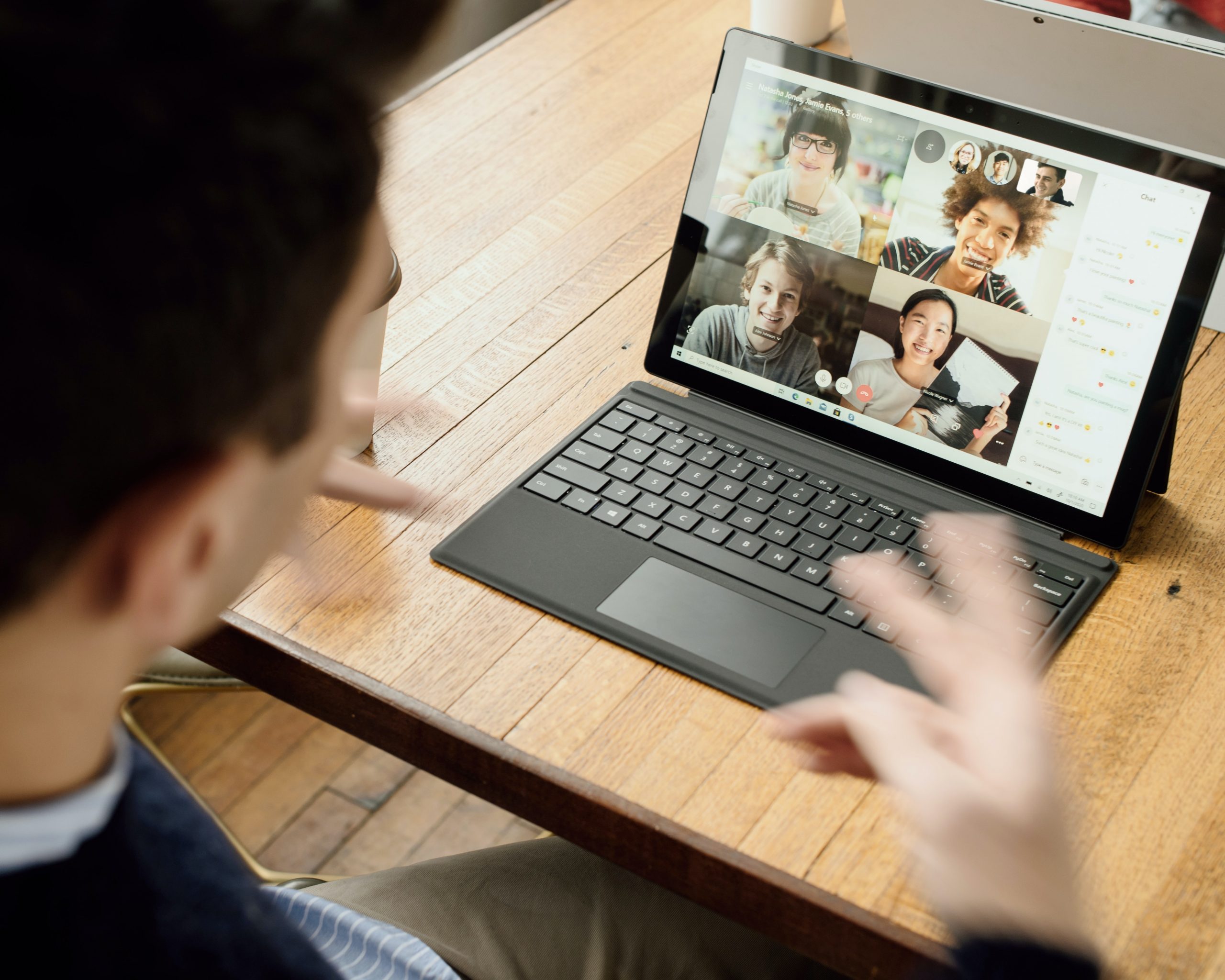 Person in blue shirt gesturing on remote conferencing software