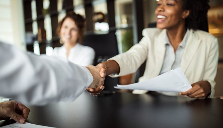 Business woman making plans with somebody, shaking hands.