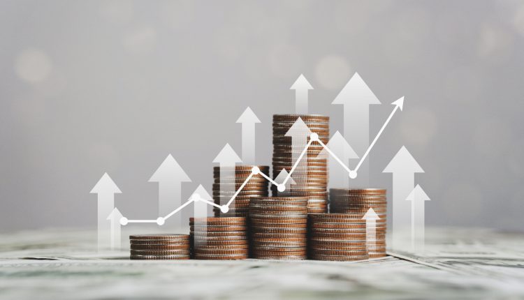 stack of silver coins with trading chart in financial concepts and financial investment business stock growth